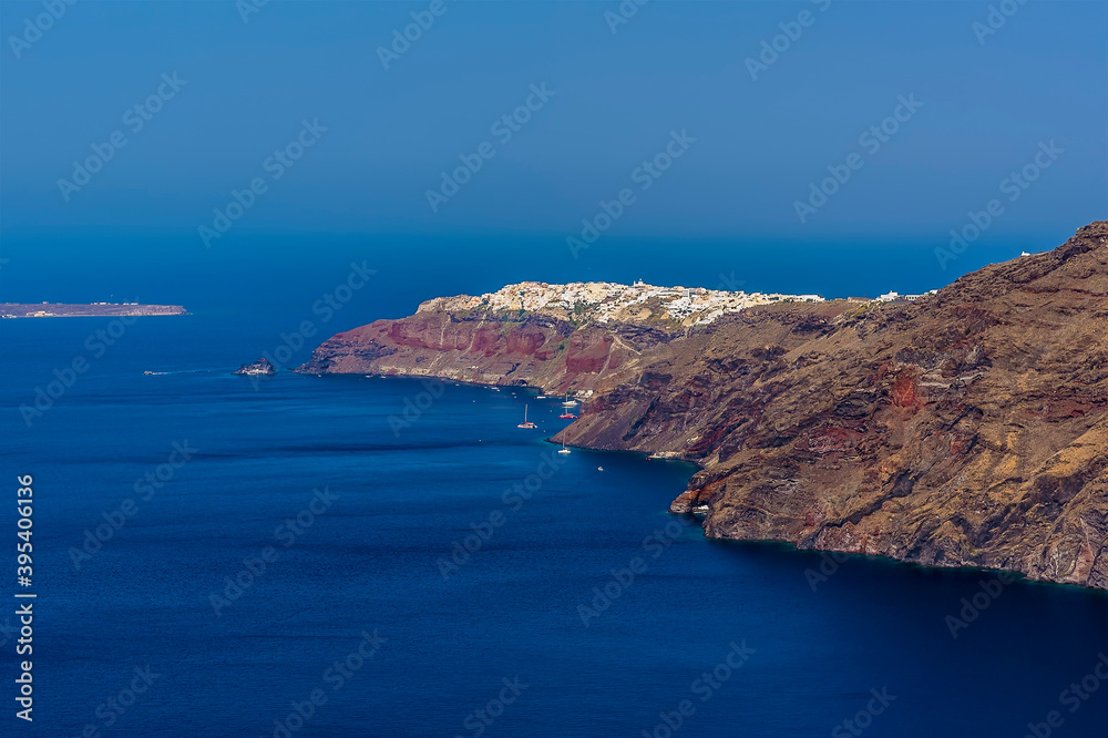 A view from the path on the Caldera rim in Santorini towards the northern tip in summertime