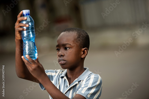 little boy holding a plastic bottle