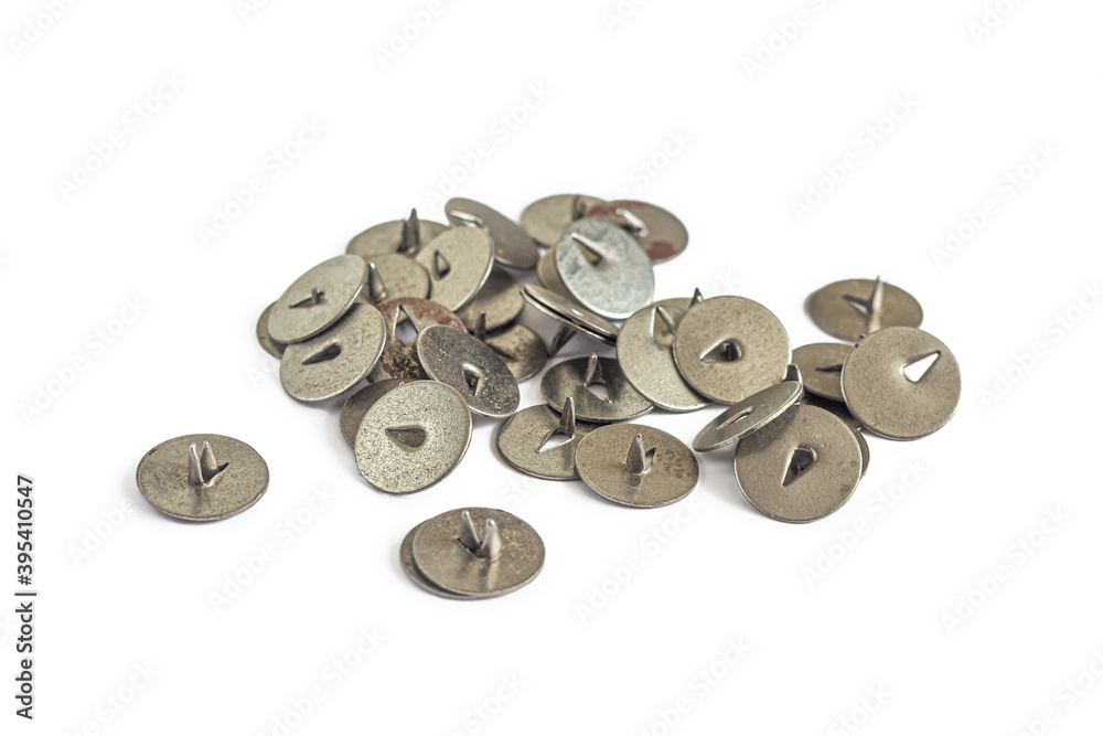 Handful of metal pushpins isolated on a white Handful of metal pushpins isolated on a white