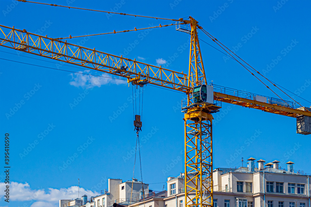 Yellow construction crane, on a construction site Yellow construction crane, on a construction site