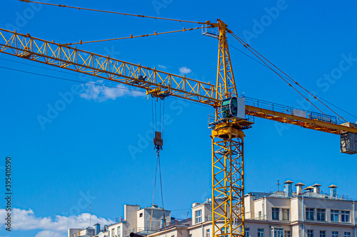 Yellow construction crane, on a construction site