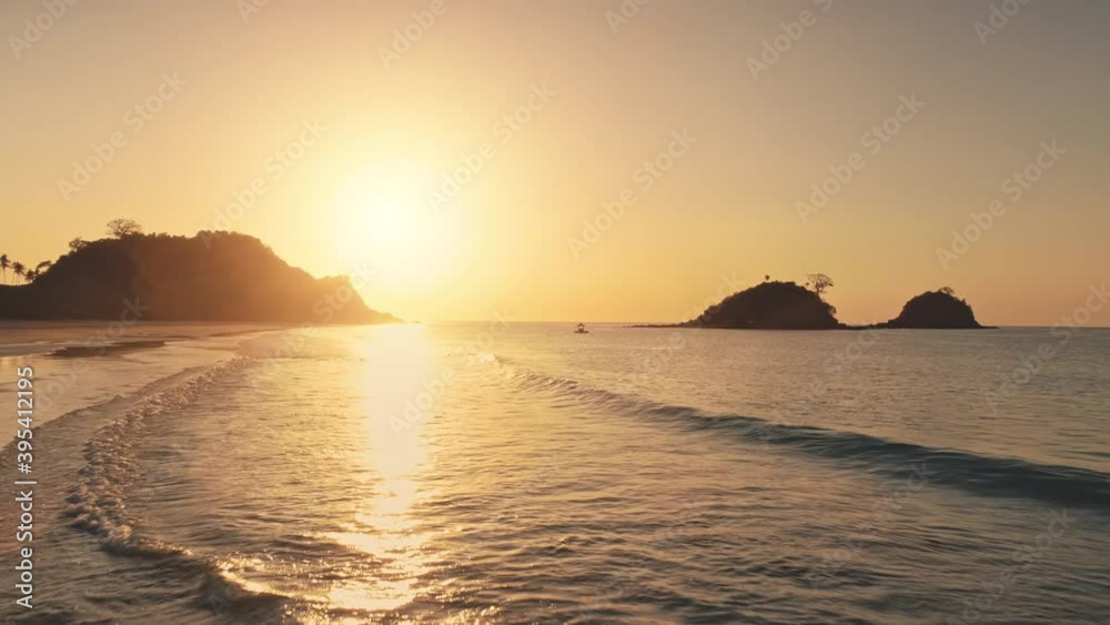 Sun reflection at waves of ocean bay aerial. Silhouette of mountains islands with tropic forest. Seascape with rock islets of Philippines archipelago. Summer marine at sunshine. Travel to paradise Sun reflection at waves of ocean bay aerial. Silhouette of mountains islands with tropic forest. Seascape with rock islets of Philippines archipelago. Summer marine at sunshine. Travel to paradise