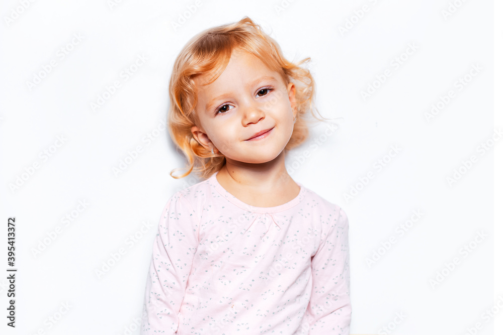 Studio portrait of child girl with curly blonde hair on background of white color. Studio portrait of child girl with curly blonde hair on background of white color.