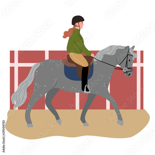 Young girl in helmet sitting on black horse back and riding on hippodrome