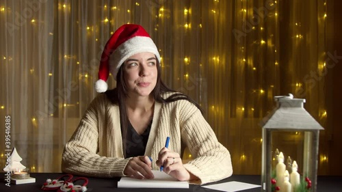 Pretty woman writing letter at Christmas time