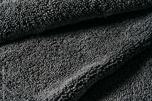 Gray cleaning rag microfiber cloth or towel for cleaning and household. Abstract dark fabric textile background. photo