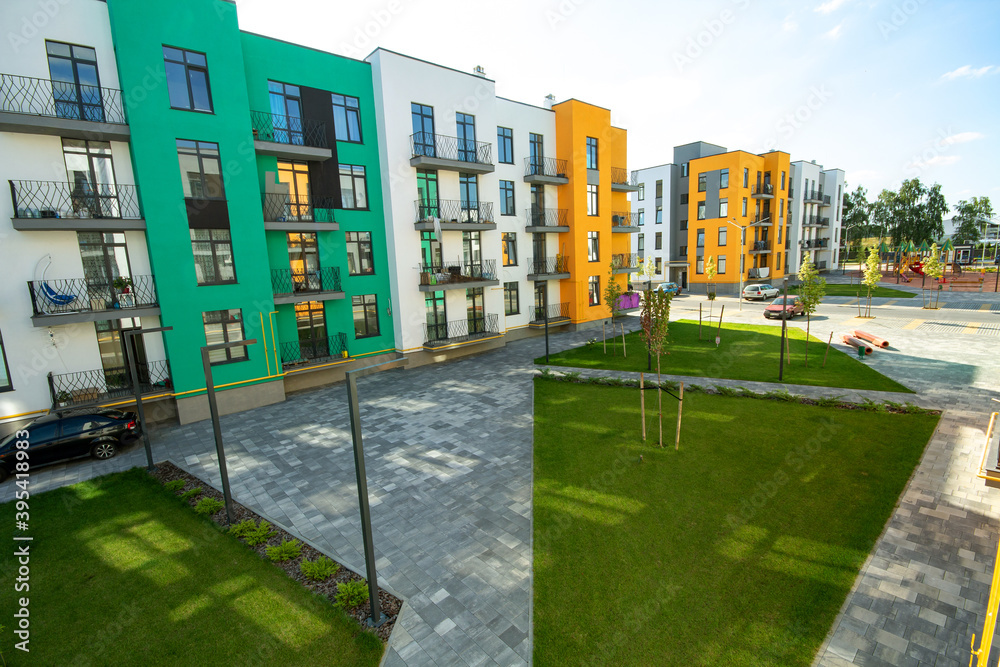 Picture of Yard between residential apartment buildings with green grass lawns and ...