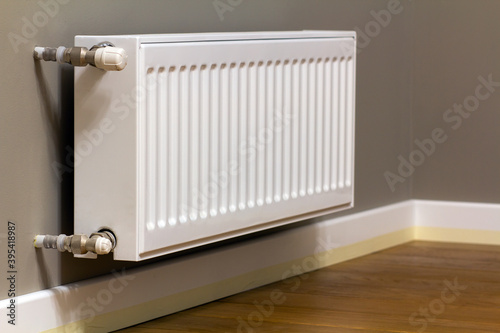 Wallpaper Mural White metal heating radiator mounted on gray wall inside a room. Torontodigital.ca