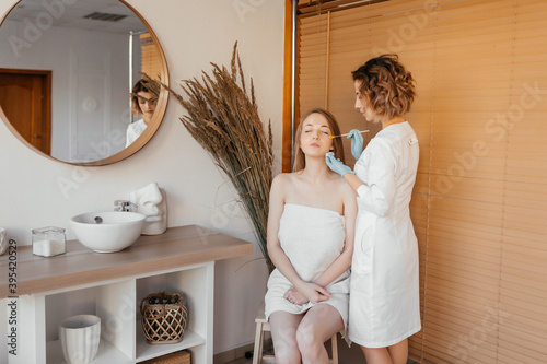 Сosmetology procedures. Skin care. Doctor in a white coat. face and eye skin care.