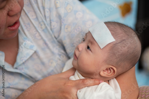 Mother on feeding 4 month baby boy milk during baby having high fever