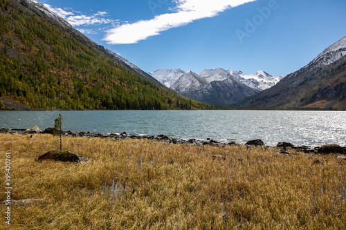 Snake river,Beautiful mountain back ground green river banks,Brown dry grass up the mountain slopes. gray overcast clouds. peaceful water flow