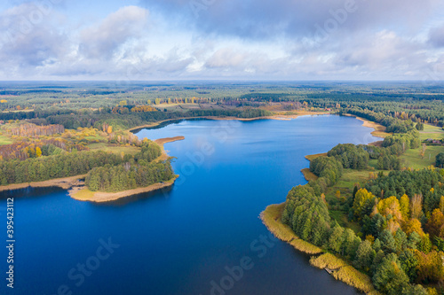 Fototapeta Naklejka Na Ścianę i Meble -  Aerial view of Omulew lake under blue cloudy sky