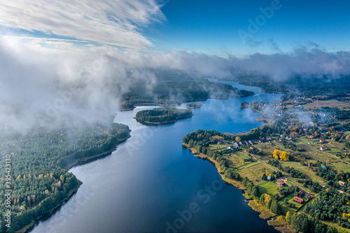 Fototapeta Naklejka Na Ścianę i Meble -  Aerial view of lake and clouds below