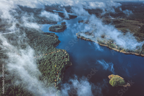 Fototapeta Naklejka Na Ścianę i Meble -  Aerial view of lake and clouds below