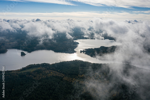Fototapeta Naklejka Na Ścianę i Meble -  Aerial view of lake and clouds below