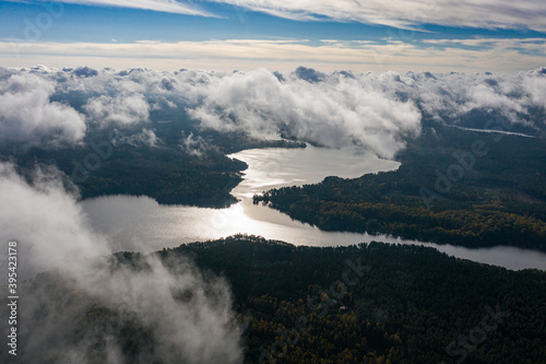 Fototapeta Naklejka Na Ścianę i Meble -  Aerial view of lake and clouds below