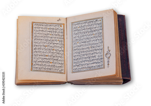 Old arabic holy Quran also romanized Qur'an or Koran, is the central religious text of Islam. Antique book with hand coloring in gold. Image showing two pages opened up in a spread.
