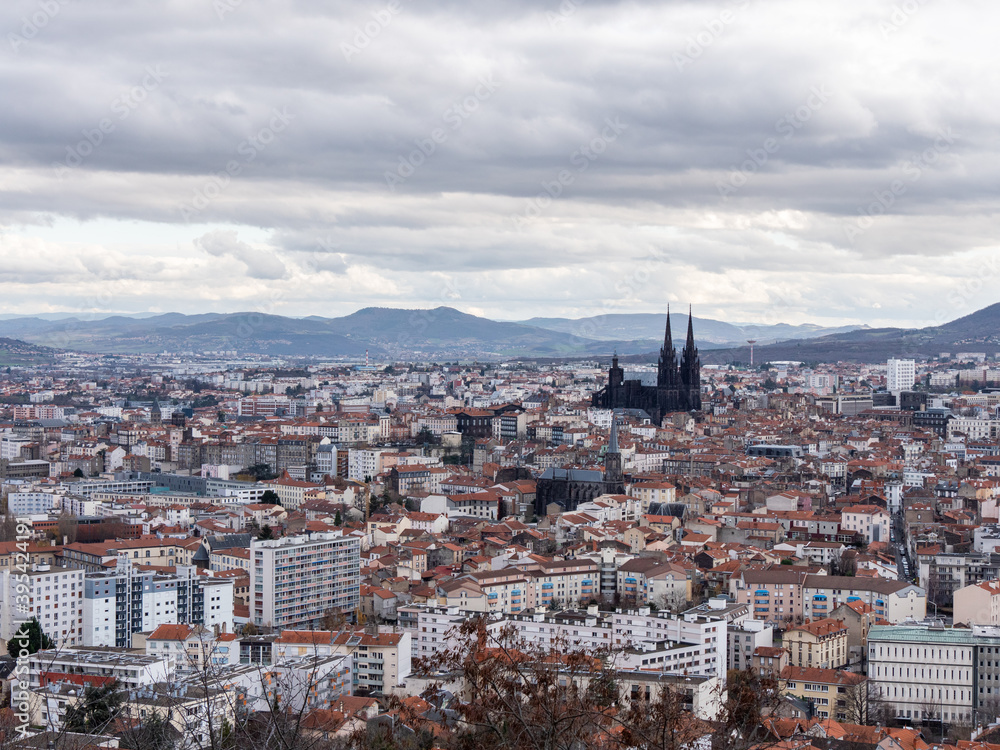 View on the city of Clermont-Ferrand, in the Auvergne, in the center of France. Busy sky. 