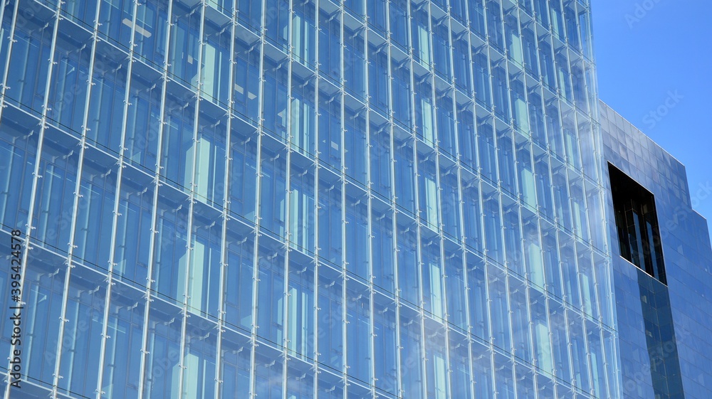 Facade texture of a glass mirrored office building. Fragment of the facade. Modern architecture of the office building. Facade texture of a glass mirrored office building. Fragment of the facade. Modern architecture of the office building.