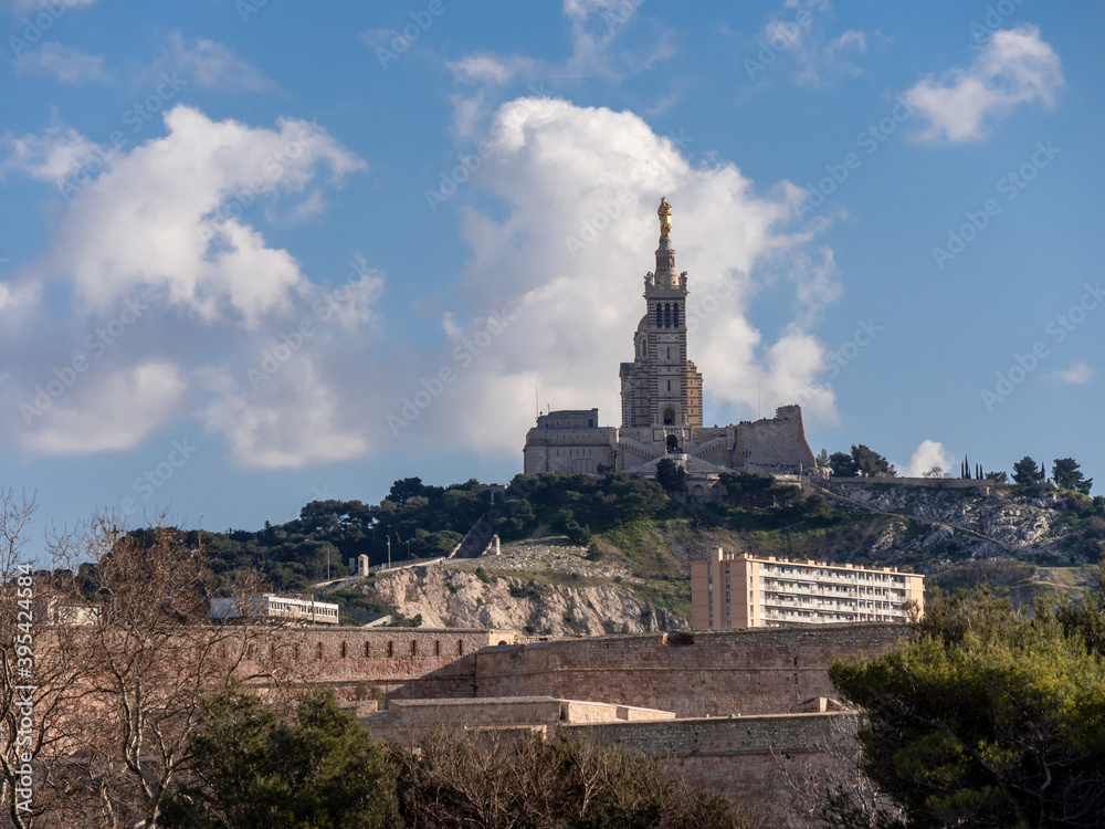 Notre-Dame de la Garde is a Catholic basilica in Marseille, France, and the city's best-known symbol. Cloudy sky. Marseille is a city located in southern France.