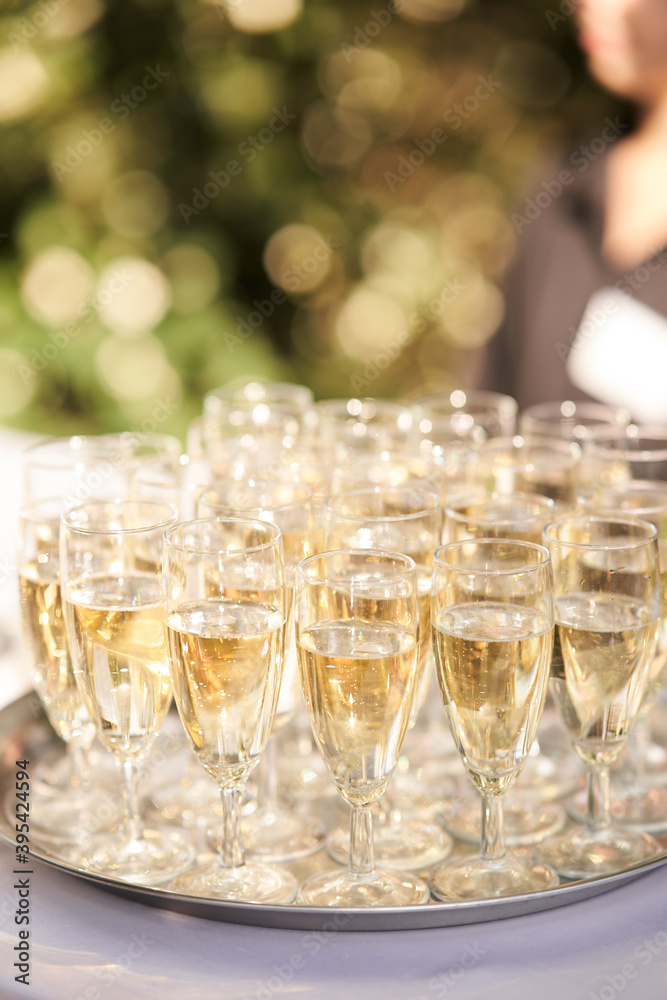Glasses of champagne on a silver tray at a family celebration Glasses of champagne on a silver tray at a family celebration