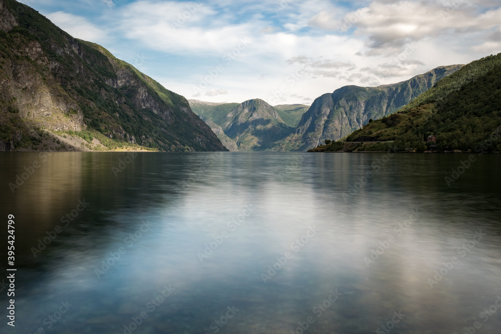 View on a fjord from the village of Flåm, Norway, Europe. Photographed in summer. Some clouds in the sky. Nobody.