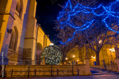 Christmas empty night street decorated festive outdoor environment space of old European town near church building © Артём Князь