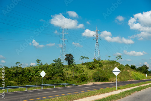 high voltage electricity pole on the edge of a highway in the Colombian countryside
