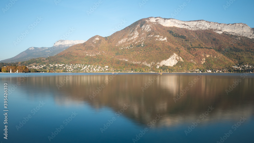 View on the famous lake of Annecy, a city located in Savoie, France. Reflection on the water. Sunny day, autumn. 