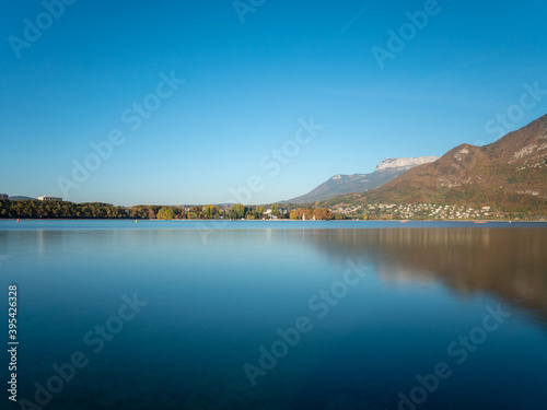 Lake Annecy (French: Lac d'Annecy) is a perialpine lake in Haute-Savoie in France. Landscape in autumn, sunny day, blue sky.