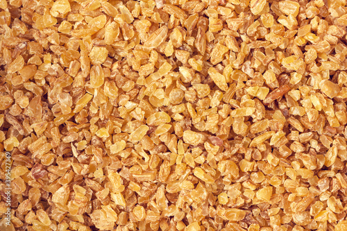 Uncooked bulgur background. Abstract food texture. Closeup view.