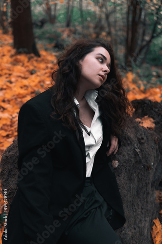 Girl in a jacket and shirt in the autumn forest
