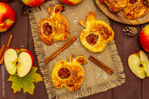 Homemade apple dessert, portioned puffs with fragrant cinnamon sticks, colorful foliage, autumn good mood