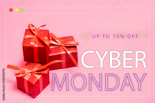 red gift boxes near up to 70 percent off, cyber monday lettering on pink blurred 