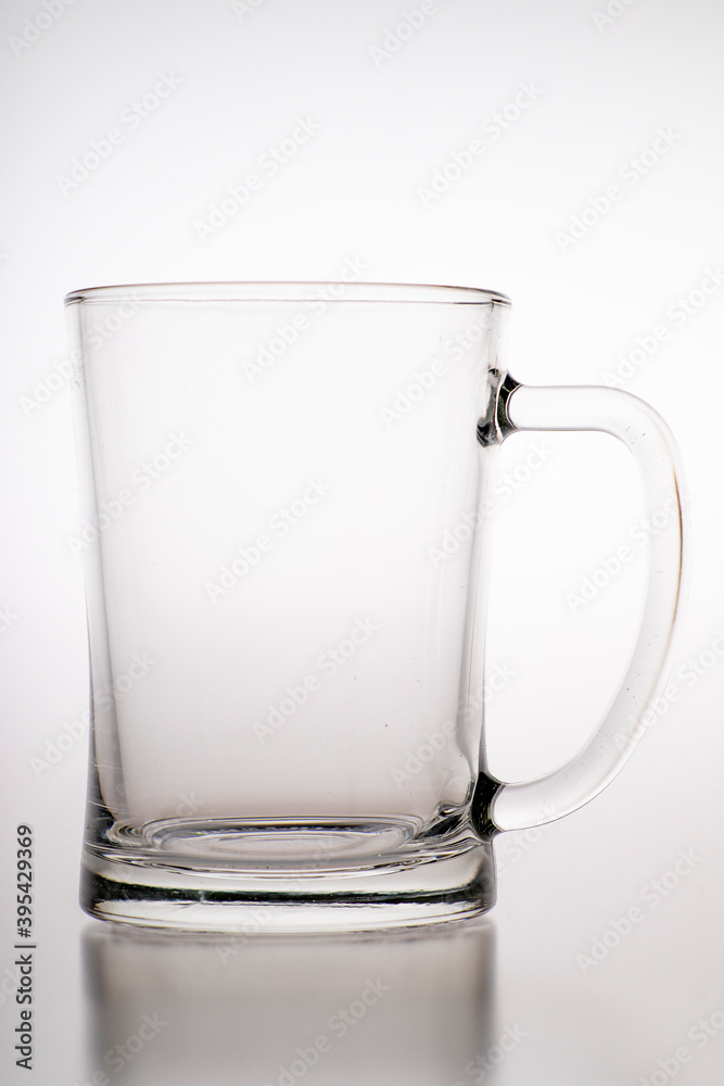 Pouring water into a mug. Glass container for weak carbonated alcohol. Pouring water into a mug. Glass container for weak carbonated alcohol.