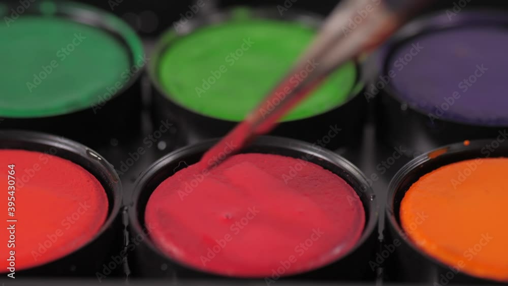 artist painter mixing red oil paint with brush on palette 4k artist painter mixing red oil paint with brush on palette 4k