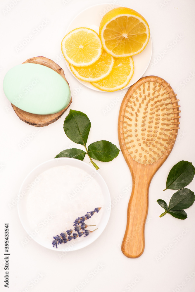 top view of brush, bowl with lavender, sliced lemon, soap, and rose leaves on white, stock image top view of brush, bowl with lavender, sliced lemon, soap, and rose leaves on white, stock image