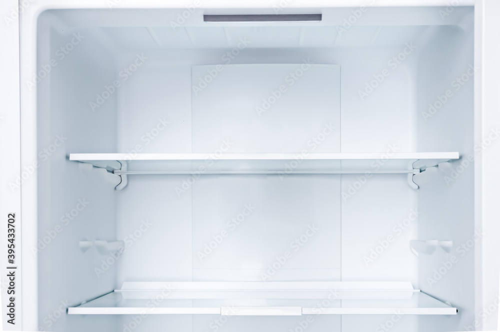 Empty open fridge with shelves, refrigerator.Copy space. Empty open fridge with shelves, refrigerator.Copy space.
