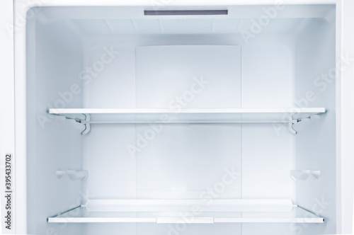 Empty open fridge with shelves, refrigerator.Copy space. photo
