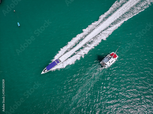 Sailing ship yachts and high speed boat at open sea. Aerial - drone view to sailboat in windy condition © Semachkovsky 