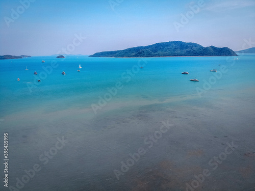 Aerial view of many anchoring yacht in open water. Ocean and sea travel and transportation. Phuket. Thailand.