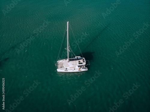 Aerial view of a sailing yacht in the turquoise water of the Andaman sea. Phuket. Thailand