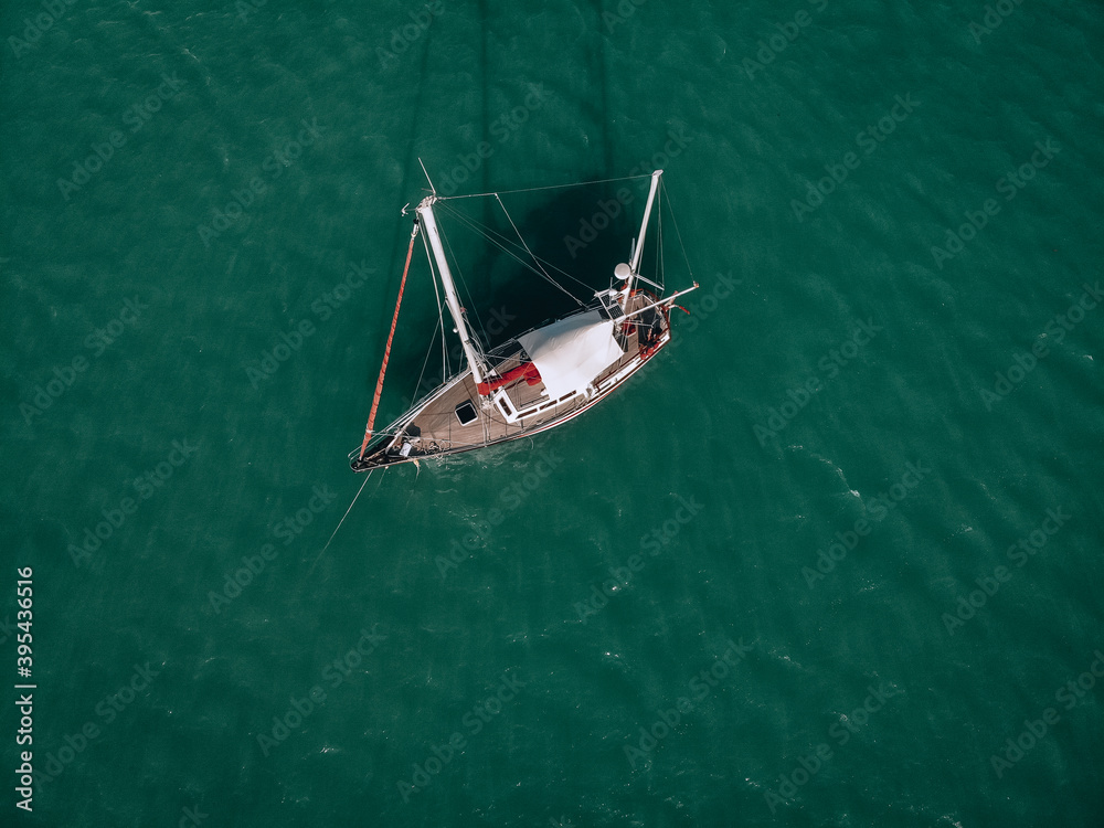 Aerial view of a sailing yacht in the turquoise water of the Andaman sea. Phuket. Thailand Aerial view of a sailing yacht in the turquoise water of the Andaman sea. Phuket. Thailand