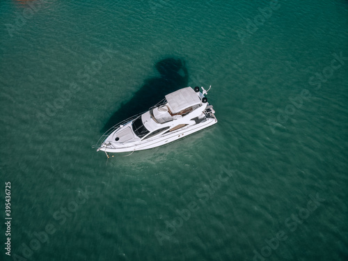 Aerial photo of an isolated luxury white  yacht design in the sea. © Semachkovsky 
