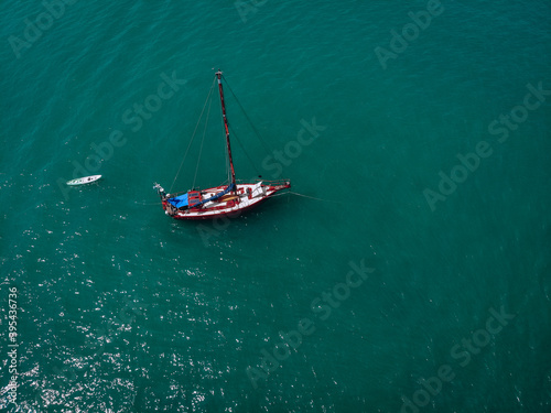 Aerial view of a sailing yacht in the turquoise water of the Andaman sea. Phuket. Thailand