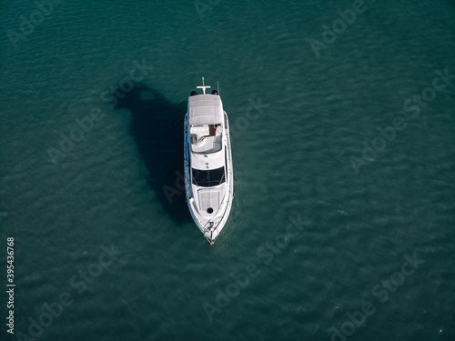Aerial photo of an isolated luxury white  yacht design in the sea. © Semachkovsky 