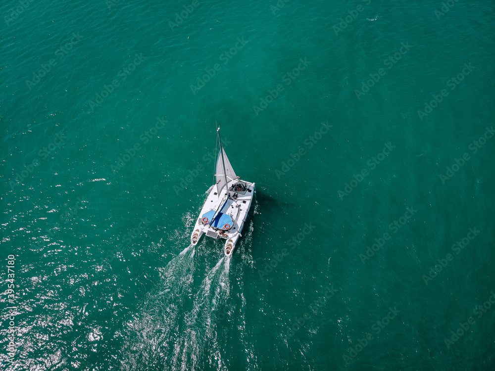 Aerial view of a  sailing yacht in the turquoise water of the Andaman sea. Phuket. Thailand