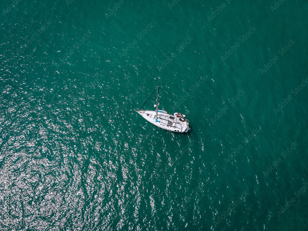 Naklejka premium Aerial view of a sailing yacht in the turquoise water of the Andaman sea. Phuket. Thailand