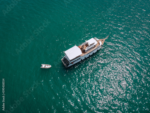 Aerial drone top view photo of luxury yacht with white rubber boat. Phuket. Thailand.. © Semachkovsky 
