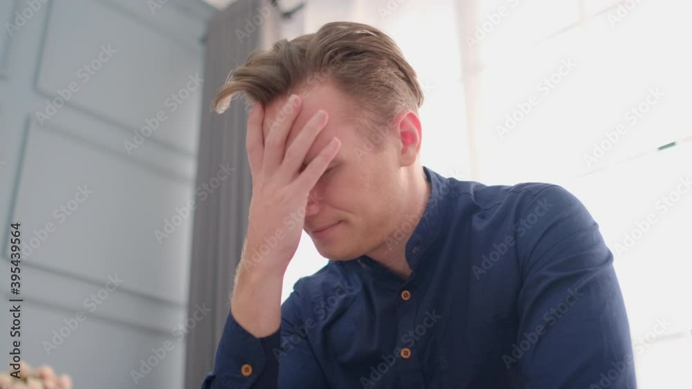 Portrait of Caucasian man express upset or feel bad with some situation and stay in living room of his house and glass window as background. Portrait of Caucasian man express upset or feel bad with some situation and stay in living room of his house and glass window as background.